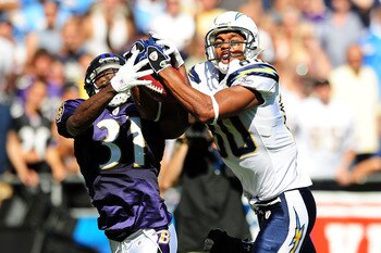 SAN DIEGO - SEPTEMBER 20:Malcolm Floyd #80 of the San Diego Chargers and Fabian Washington #31 of the Baltimore Ravens both catch the ball  at Qualcomm Stadium on September 20, 2009 in San Diego, California.  (Photo by Jacob de Golish/Getty Images)