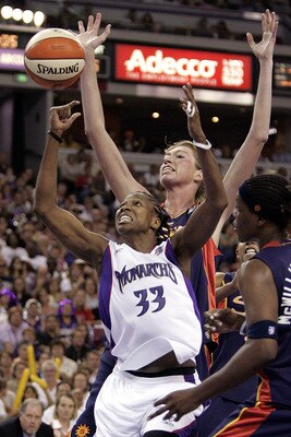 SACRAMENTO, CA - SEPTEMBER 18:   Yolanda Griffith #33 of the Sacramento Monarchs battles with Taj McWilliams-Fran #11 and Margo Dydek #12 of the Connecticut Sun during Game 3 of the WNBA finals on September 18, 2005 at the ARCO Arena in Sacramento, Califo