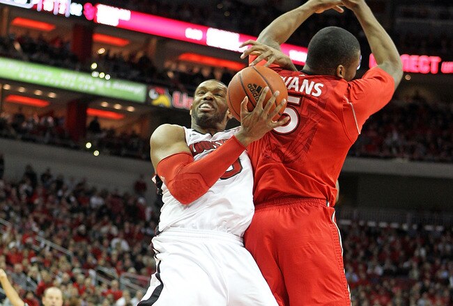 LOUISVILLE, KY - JANUARY 19: George Goode #0 of the Louisville Cardinals and Sean Evans #5 of the St. John's Red Storm battle for a rebound during the Big East Conference game at the KFC Yum! Center on January 19, 2011 in Louisville, Kentucky.  Louisville