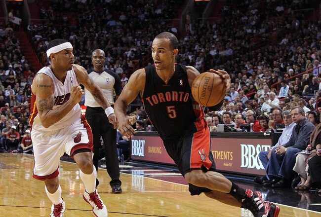 MIAMI, FL - JANUARY 22:  Jerryd Bayless #5 of the Toronto Raptors dribbles past Eddie House #55 of the Miami Heat during a game at American Airlines Arena on January 22, 2011 in Miami, Florida. NOTE TO USER: User expressly acknowledges and agrees that, by