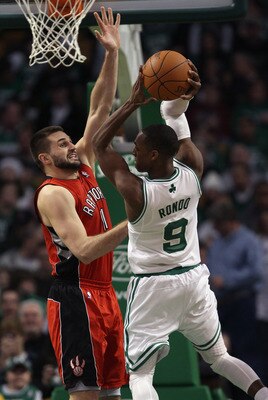 BOSTON, MA - JANUARY 07:  Linas Kleiza #11 of the Toronto Raptors tries to block Rajon Rondo #9 of the Boston Celtics on January 7, 2011 at the TD Garden in Boston, Massachusetts. The Celtics defeated the Raptors 122-102. NOTE TO USER: User expressly ackn