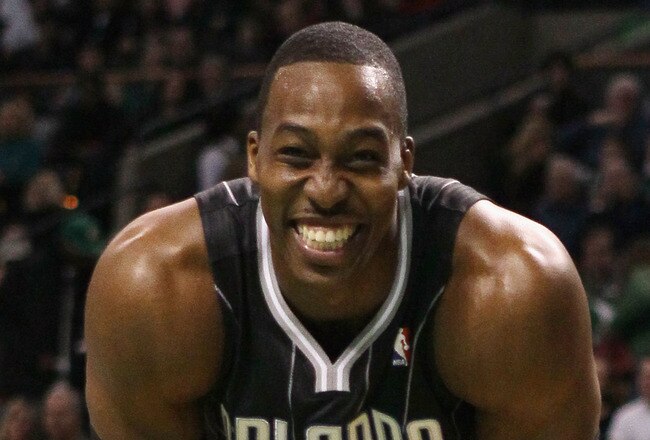 BOSTON, MA - JANUARY 17:  Dwight Howard #12 of the Orlando Magic smiles on the baseline as he waits for Shaquille O'Neal of the Boston Celtics to shoot a free throw on January 17, 2011 at the TD Garden in Boston, Massachusetts.  NOTE TO USER: User express