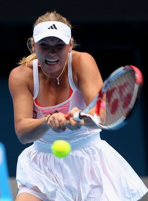 MELBOURNE, AUSTRALIA - JANUARY 21:  Caroline Wozniacki of Denmark plays a backhand in her third round match against  Dominika Cibulkova of Slovakia during day five of the 2011 Australian Open at Melbourne Park on January 21, 2011 in Melbourne, Australia.