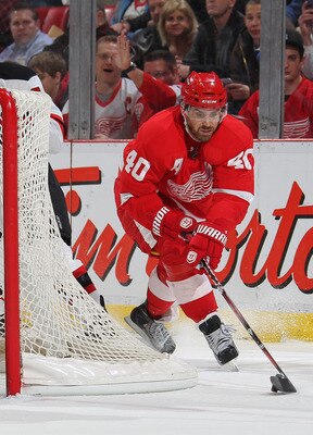 DETROIT, MI - JANUARY 26:  Henrik Zetterberg #40 of the Detroit Red Wings swings around the net for a shot on Martin Brodeur #30 of the New Jersey Devils in a game on January 26, 2011 at the Joe Louis Arena in Detroit, Michigan. The Wings defeated the Dev
