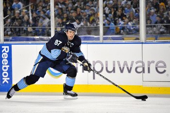 PITTSBURGH, PA - JANUARY 01:  Sidney Crosby #87 of the Pittsburgh Penguins looks to pass against the Washington Capitals during the 2011 NHL Bridgestone Winter Classic at Heinz Field on January 1, 2011 in Pittsburgh, Pennsylvania. Washington won 3-1. (Pho