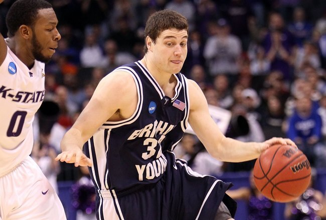 OKLAHOMA CITY - MARCH 20:  Jimmer Fredette #32 of the Brigham Young Cougars drives against Jacob Pullen #0 of the Kansas State Wildcats during the second round of the 2010 NCAA men's basketball tournament at Ford Center on March 20, 2010 in Oklahoma City,