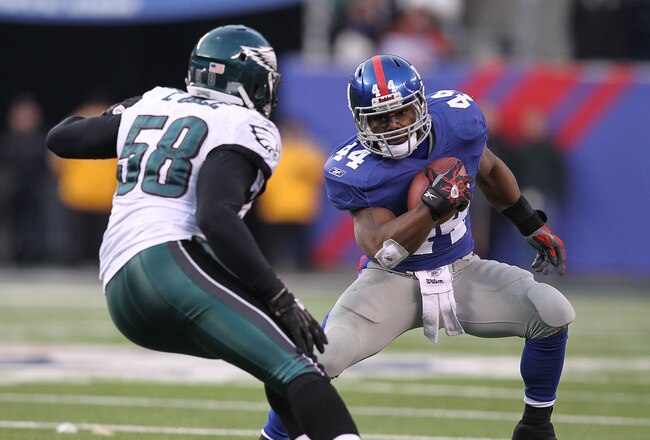 EAST RUTHERFORD, NJ - DECEMBER 19:  Ahmad Bradshaw #44 of the New York Giants runs with the ball as Trent Cole #58 of the Philadelphia Eagles defends during their game on December 19, 2010 at The New Meadowlands Stadium in East Rutherford, New Jersey.  (P
