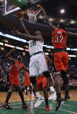 BOSTON, MA - JANUARY 07:  Shaquille O'Neal #36 of the Boston Celtics heads for the basket as Julian Wright #14 and Ed Davis #32 of the Toronto Raptors defend on January 7, 2011 at the TD Garden in Boston, Massachusetts. NOTE TO USER: User expressly acknow