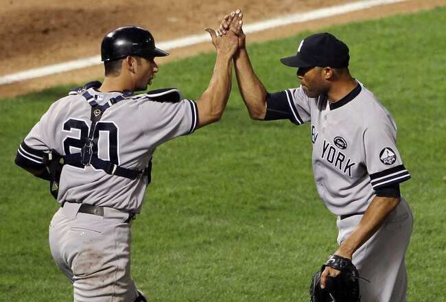 ARLINGTON, TX - OCTOBER 15:  Mariano Rivera #42 and Jorge Posada #20 of the New York Yankees celebrate after defeating the Texas Rangers by a score of 6-5 to win Game One of the ALCS during the 2010 MLB Playoffs at Rangers Ballpark in Arlington on October