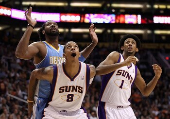 PHOENIX - NOVEMBER 15:  Channing Frye #8 of the Phoenix Suns blocks out Nene #31 of the Denver Nuggets during the NBA game at US Airways Center on November 15, 2010 in Phoenix, Arizona. NOTE TO USER: User expressly acknowledges and agrees that, by downloa