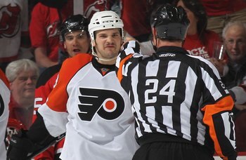 NEWARK, NJ - APRIL 14: Daniel Carcillo #13 of the Philadelphia Flyers argues a penalty call with referee Stephen Walkom #24 during the game against the New Jersey Devils in Game One of the Eastern Conference Quarterfinals during the 2010 NHL Stanley Cup P