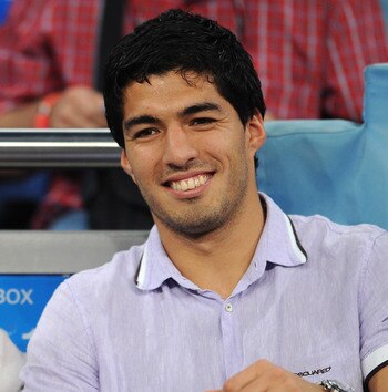 MADRID, SPAIN - SEPTEMBER 15:  Expelled Ajax player Luis Suarez (R) hold his baby daughter Delfina while seated next to his wife Sofia prior to the start of the UEFA Champions League group G match between Real Madrid and Ajax at the Estadio Santiago Berna
