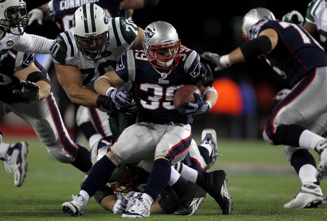 FOXBORO, MA - JANUARY 16:  Mike DeVito #70 of the New York Jets tackles Danny Woodhead #39 of the New England Patriots during their 2011 AFC divisional playoff game at Gillette Stadium on January 16, 2011 in Foxboro, Massachusetts.  (Photo by Jim Rogash/G