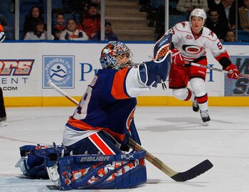 UNIONDALE, NY - JANUARY 26:  Jeff Skinner #53 of the Carolina Hurricanes skates toward the goal as goalie Rick DiPietro #39 of the New York Islanders catches a shot from the point during the third period of an NHL hockey game at the Nassau Coliseum on Jan