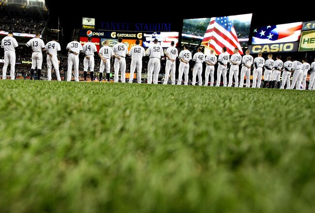 NEW YORK - OCTOBER 18:  The American Flag is seen on the video screen during the National Anthem as the Yankees and Texas Rangers stand on the foul lines prior to playing in Game Three of the ALCS during the 2010 MLB Playoffs at Yankee Stadium on October
