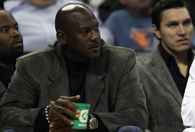 CHARLOTTE, NC - NOVEMBER 08:  Michael Jordan, owner of the Charlotte Bobcats, sits on the bench with Stephen Jackson #1 during their game against the San Antonio Spurs at Time Warner Cable Arena on November 8, 2010 in Charlotte, North Carolina.  NOTE TO U