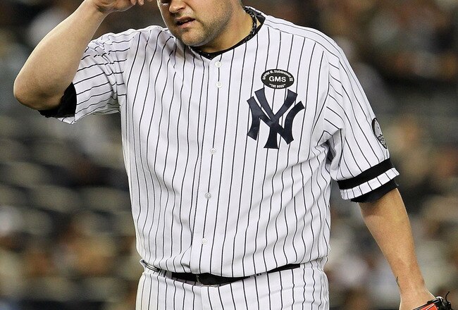 NEW YORK - OCTOBER 19:  Joba Chamberlain #62 of the New York Yankees reacts as he walks back to the dugout at the end of the top of the eighth inning against the Texas Rangers in Game Four of the ALCS during the 2010 MLB Playoffs at Yankee Stadium on Octo
