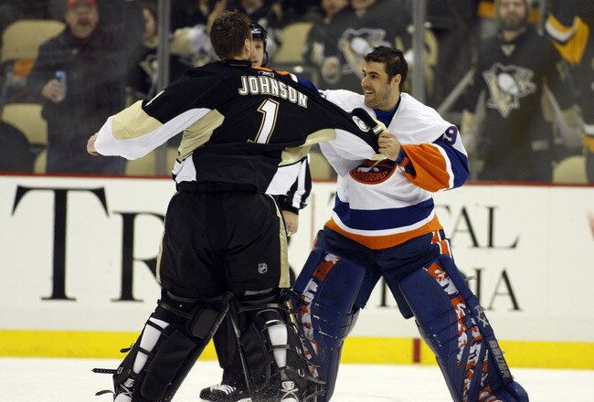 PITTSBURGH, PA - FEBRUARY 02:  Rick DiPietro #39 of the New York Islanders mixes it up against Brent Johnson #1 of the Pittsburgh Penguins at Consol Energy Center on February 2, 2011 in Pittsburgh, Pennsylvania.  The Penguins shut out the Islanders 3-0.