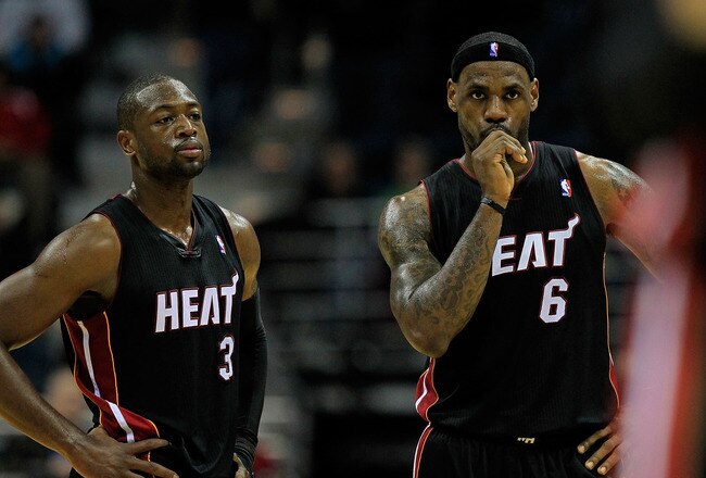 MILWAUKEE, WI - DECEMBER 06: (L-R) Dwyane Wade #3 and LeBron James #6 of the Miami Heat watch as a teammate readies to shoot a free-throw against the Milwaukee Bucks at the Bradley Center on December 6, 2010 in Milwaukee, Wisconsin. The Heat defeated the