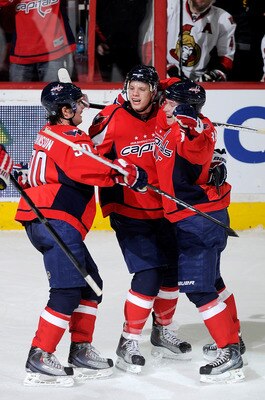 WASHINGTON, DC - JANUARY 16:  John Carlson #74 of the Washington Capitals celebrates with Marcus Johansson #90 and Nicklas Backstrom #19 after scoring the game winning goal against the Ottawa Senators at the Verizon Center on January 16, 2011 in Washingto