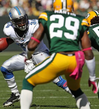 GREEN BAY, WI - OCTOBER 03: Kevin Smith #34 of the Detroit Lions tries to run against Nick Barnett #56 and Derrick Martin #29 of the Green Bay Packers at Lambeau Field on October 3, 2010 in Green Bay, Wisconsin. The Packers defeated the Lions 28-26.  (Pho