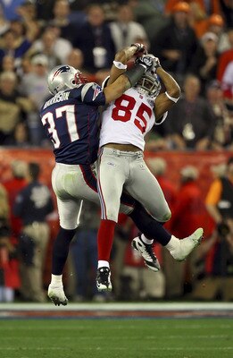 GLENDALE, AZ - FEBRUARY 03:  David Tyree #85 of the New York Giants catches a 32-yard pass from Eli Manning #10 as Rodney Harrison #37 of the New England Patriots attempts to knock it out in the fourth quarter of Super Bowl XLII on February 3, 2008 at the