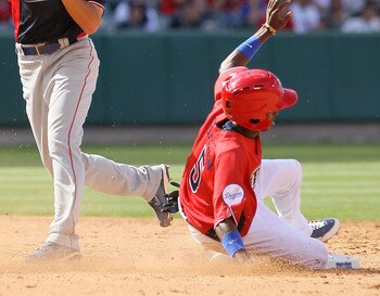 ANAHEIM, CA - JULY 11:  World Futures All-Star Hak-Ju Lee #31 of the Chicago Cubs throws the ball as U.S. Futures All-Star Dee Gordon #5 of the Los Angeles Dodgers slides into base during the 2010 XM All-Star Futures Game at Angel Stadium of Anaheim on Ju