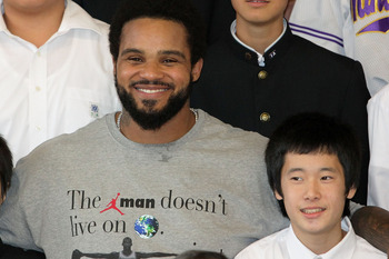 TOKYO - DECEMBER 15:  Prince Fielder (C) of the Milwaukee Brewers poses with students while visiting Minamisuna Junior High School as part of the Major League Baseball (MLB) International Ambassador program to promote the game of baseball on December 15,