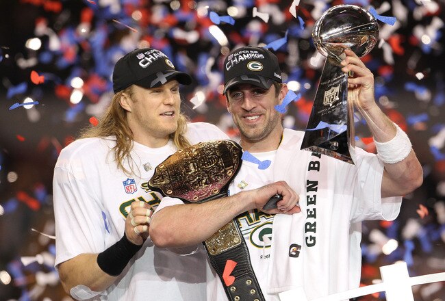 ARLINGTON, TX - FEBRUARY 06:  Aaron Rodgers #12 and Clay Matthews #52 of the Green Bay Packers of the Green Bay Packers holds the Lombardi Trophy after defeating the Pittsburgh Steelers 31-25 during Super Bowl XLV at Cowboys Stadium on February 6, 2011 in
