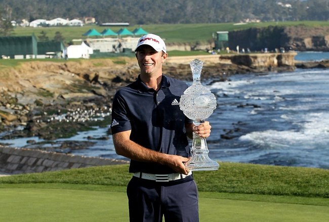PEBBLE BEACH, CA - FEBRUARY 14:  Dustin Johnson poses with the trophy on the 18th green after the final round of the AT&T Pebble Beach National Pro-Am at Pebble Beach Golf Links on February 14, 2010 in Pebble Beach, California.  (Photo by Stephen Dunn/Get