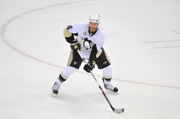 DETROIT - JUNE 12:  Rob Scuderi #4 of the Pittsburgh Penguins handles the puck against the Detroit Red Wings during Game Seven of the 2009 NHL Stanley Cup Finals at Joe Louis Arena on June 12, 2009 in Detroit, Michigan. (Photo by Jamie Sabau/Getty Images)