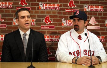 BOSTON, MA - DECEMBER 06:  Adrian Gonzalez (R) ooks on as General Manager Theo Epstein answers questions during a press conference to announce Gonzalez signing with the Boston Red Sox on December 6,  2010 at Fenway Park in Boston, Massachusetts.  (Photo b