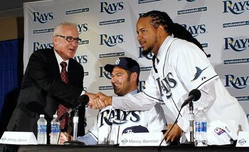 ST PETERSBURG, FL - FEBRUARY 01:  The Tampa Bay Rays manager Joe Maddon shakes hands with Manny Ramirez #24 of the Tampa Bay Rays as Johnny Damon #22 of the Tampa Bay Rays looks on during a press conference at Tropicana Field on February 1, 2011 in St. Pe