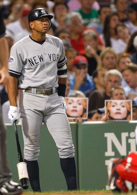 BOSTON - JULY 25: Fans hold pictures of Madonna as Alex Rodriguez #13 of the New York Yankees prepares to bat against the Boston Red Sox at Fenway Park on July 25, 2008 in Boston, Massachusetts.  (Photo by Jim Rogash/Getty Images)