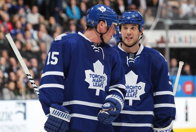 TORONTO, CAN - FEBRUARY 7:  Tim Brent #37 and Tomas Kaberle #15 of the Toronto Maple Leafs chat prior to a faceoff in a game against the Atlanta Thrashers on February 7, 2011 at the Air Canada Centre in Toronto, Canada. The Leafs defeated the Thrashers 5-
