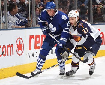TORONTO, CAN - FEBRUARY 7:  Chris Thorburn #27 of the Atlanta Thrashers battles with Tomas Kaberle #15 of the Toronto Maple Leafs for puck posession in a game on February 7, 2011 at the Air Canada Centre in Toronto, Canada. The Leafs defeated the Thrasher