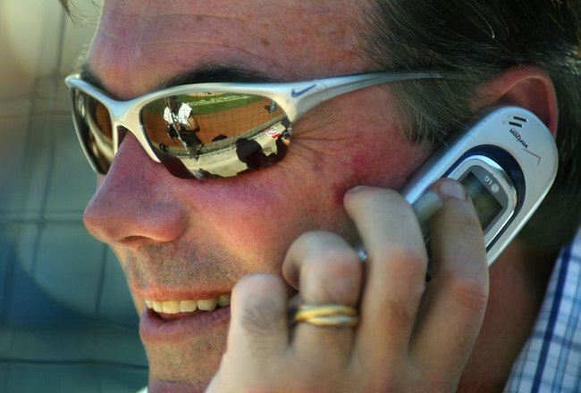 PHOENIX - MARCH 03:  General manager Billy Beane of the Oakland Athletics talks on the phone during the MLB Spring Training game against the Milwaukee Brewers at Phoenix Municipal Stadium on March 3, 2006 in Phoenix, Arizona.  The Brewers defeated the A's