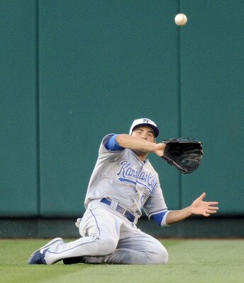 ANAHEIM, CA - JULY 02:  David DeJesus #9 of the Kansas City Royals slides as he makes a catch for an out of Torii Hunter #48 of the Los Angeles Angels during the first inning at Angel Stadium on July 2, 2010 in Anaheim, California.  (Photo by Harry How/Ge