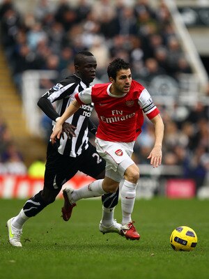 NEWCASTLE UPON TYNE, ENGLAND - FEBRUARY 05:  Cesc Fabregas of Arsenal breaks away from Cheik Tiote of Newcastle during the Barclays Premier League match between Newcastle United and Arsenal at St James' Park on February 5, 2011 in Newcastle upon Tyne, Eng