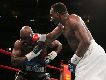 NEW YORK - NOVEMBER 13:  Larry Donald (R) lands a right to the face of Evander Holyfield during their bout for the NABC Heavyweight Championship on November 13, 2004 at Madison Square Garden in New York City.  (Photo by Al Bello/Getty Images)