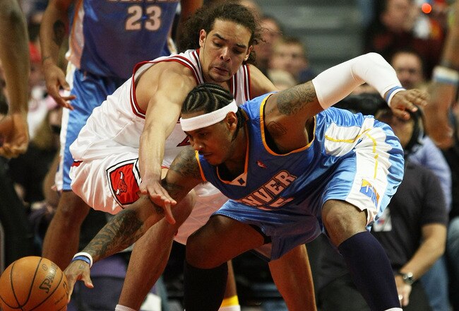 CHICAGO - FEBRUARY 22: Joakim Noah #13 of the Chicago Bulls battles for a loose ball with Carmelo Anthony #15 of the Denver Nuggets on February 22, 2008 at the United Center in Chicago, Illinois. NOTE TO USER: User expressly acknowledges and agreees that,