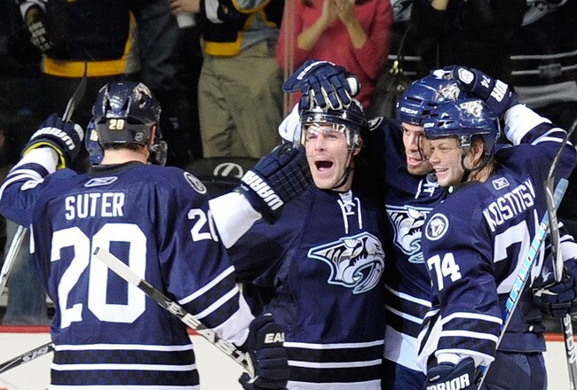 NASHVILLE, TN - FEBRUARY 12:   Ryan Suter #20, Mike Fisher #12, Shea Weber #6, and Sergei Kostitsyn #74 of the Nashville Predators celebrate after a goal against the Colorado Avalanche on February 12, 2011 at the Bridgestone Arena in Nashville, Tennessee.