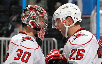 ATLANTA, GA - FEBRUARY 13:  Erik Cole #26 and goaltender Cam Ward #30 of the Carolina Hurricanes celebrate after their 3-2 win over the Atlanta Thrashers at Philips Arena on February 13, 2011 in Atlanta, Georgia.  Cole scored the game-winning goal in the