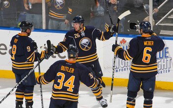 BUFFALO, NY - DECEMBER 09: Derek Roy #9,Chris Butler #34, Thomas Vanek #26 and Mike Weber #6  of the Buffalo Sabres celebrate Vanek's goal in the second period against the San Jose Sharks at HSBC Arena on December 9, 2010 in Buffalo, New York.  (Photo by