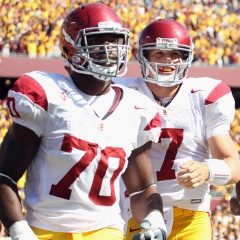 MINNEAPOLIS - SEPTEMBER 18:  Quarterback Matt Barkley #7 of the USC Trojans, flanked by Tyron Smith #70 and Ronald Johnson #83, runs off the field after the Trojans scored a touchdown during the first half of the game against the Minnesota Golden Gophers