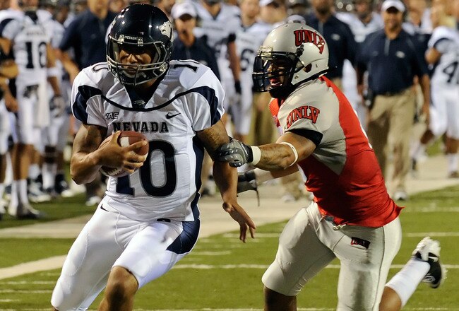 LAS VEGAS - OCTOBER 02:  Quarterback Colin Kaepernick #10 of the Nevada Reno Wolf Pack gets away from Mike Clausen #6 of the UNLV Rebel en route to scoring a touchdown in the first quarter of their game at Sam Boyd Stadium October 2, 2010 in Las Vegas, Ne