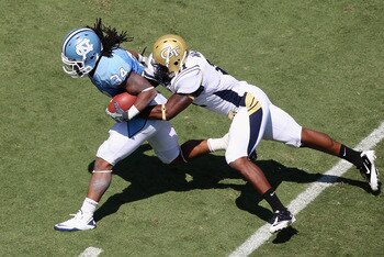 CHAPEL HILL, NC - SEPTEMBER 18:  Brandon Watts #11 of the Georgia Tech Yellow Jackets tackles Johnny White #34 of the North Carolina Tar Heels during their game at Kenan Stadium on September 18, 2010 in Chapel Hill, North Carolina.  (Photo by Streeter Lec