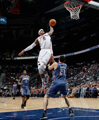 ATLANTA, GA - FEBRUARY 12:  Josh Smith #5 of the Atlanta Hawks dunks over Eduardo Najera #21 of the Charlotte Bobcats at Philips Arena on February 12, 2011 in Atlanta, Georgia.  NOTE TO USER: User expressly acknowledges and agrees that, by downloading and