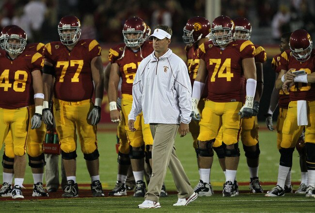 LOS ANGELES, CA - SEPTEMBER 11:  Head coach Lane Kiffin watches the USC Trojans warm up for their game with the Virginia Cavaliers at Los Angeles Memorial Coliseum on September 11, 2010 in Los Angeles, California.  (Photo by Stephen Dunn/Getty Images)