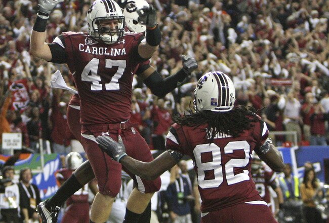 ATLANTA - DECEMBER 4:  Fullback Patrick DiMarco #47 of the South Carolina Gamecocks celebrates a touchdown while teammate and wide receiver D.L. Moore #82 joins him during the 2010 SEC Championship against the Auburn Tigers at Georgia Dome on December 4,